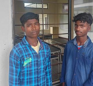 Bandhan Manxi (right) with his friend Sanjib Kondo outside his classroom in the model school.