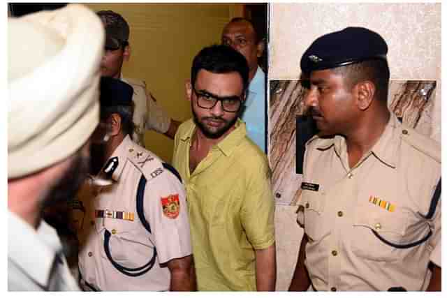 Delhi Police officials with Umar Khalid (via Getty Images)