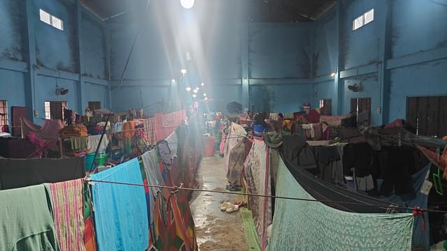  Flimsy partitions divide living spaces in the cramped relief camp