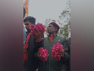 Iqbal Ansari holding flowers during PM Modi's roadshow in Ayodhya 