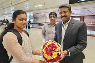 Ann Tessa Joseph being welcomed by passport officer at Cochin International Airport 