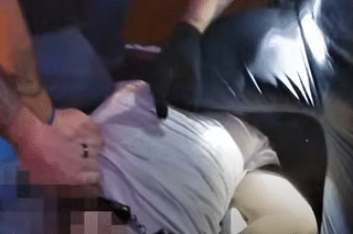 Frank Tyson being pinned on the ground by the US Cops (Pic Via YouTube screengrab)