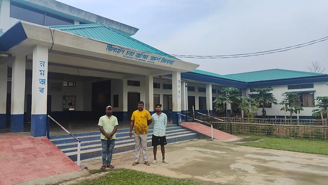(Left to right) Amlush Urang, Monil Manxi and Amar Dhonowar in front of the pride of Nilmoni — the new model school.