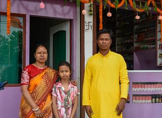 Bijay Kymar Singha with his wife Nilima and daughter Drisha in front of his new pharmacy (Image credit: Sayan Sarkar)