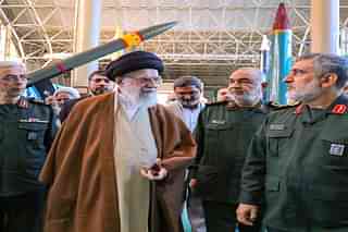 Supreme Leader Ayatollah Ali Khamenei, in brown robe with Iranian military leaders.
