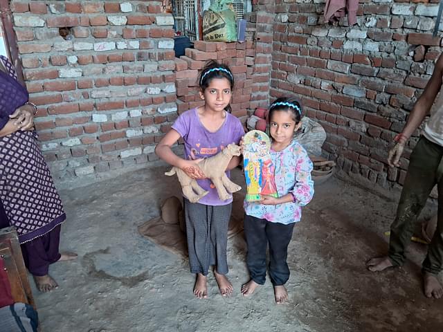 Vijay's daughters (12 and 10 years old) showing toys and murti they made while learning the craft. (AnkitSaxena/Swarajya)