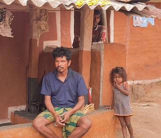 Ramo Majhi sitting in front of his house at Phuldumer village.