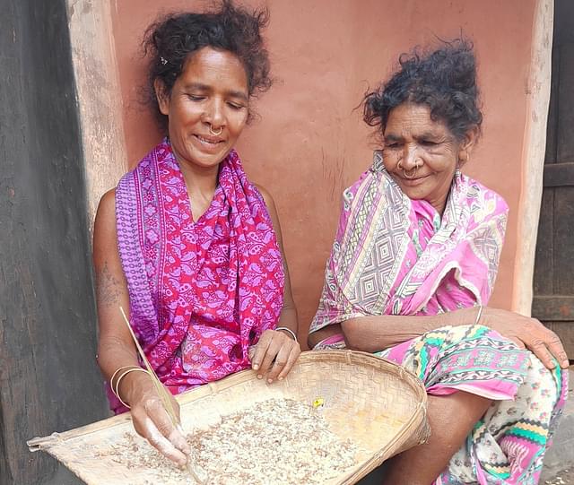 Sonari Majhi (left) of Khemondipadar village sorting ant eggs with her friend Soni