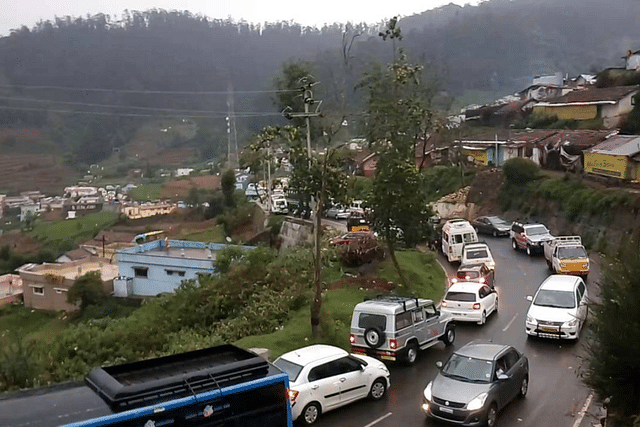 Cars lined up on a road up a hill (Representative image)