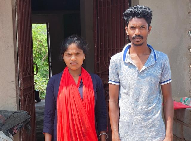 Urmila Khura with her husband in front of their house in Taupadar village.