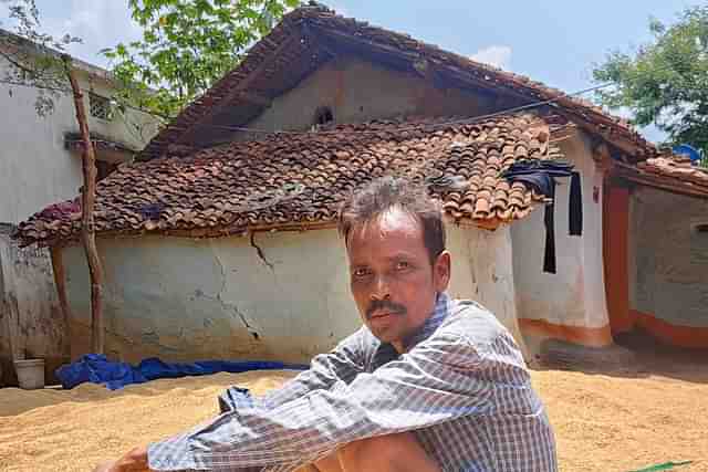 Purna Gouda with his entire harvest that he will have to give to the landowner