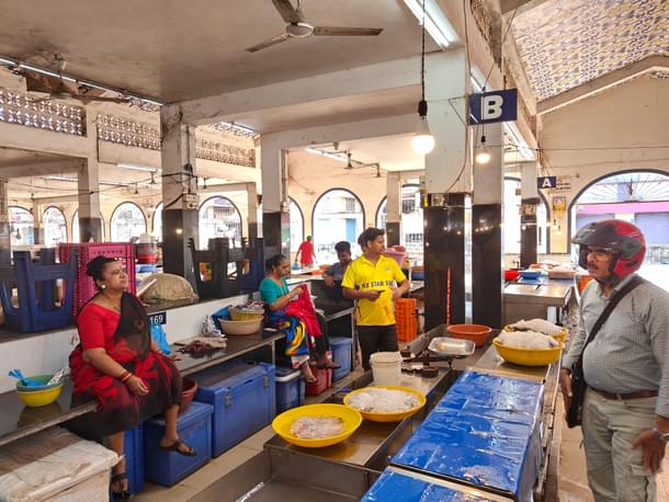Women selling fish, prawns and more in the market.
