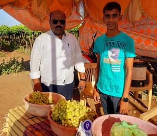 Avinash Bhujbal, a resident of Baramati town along with a grape seller along the Kanheri-Jalochi road.