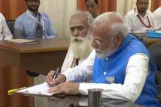 PM Narendra Modi filing nomination papers with Hindu saint who decided the muhurt (auspicious time) for the pran-pratishtha (consecration ceremony) of Ramlalla at the Ayodhya temple.