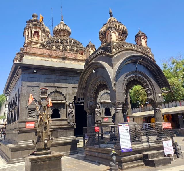 A Deepmaal i.e the lamp post; a canopy for the Nandi-lord Shiva's vehicle and the the main Siddheshwar temple's structure in the back.