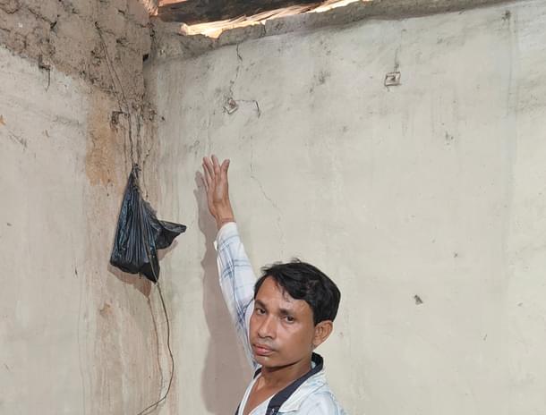 Phaguram Rana shows the cracks in walls of his due due to blasting in the mines