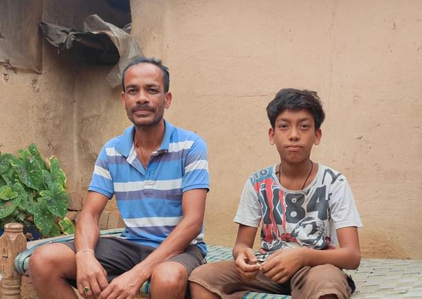 Prakash Majhi with his son Tushar in the inner courtyard of his house