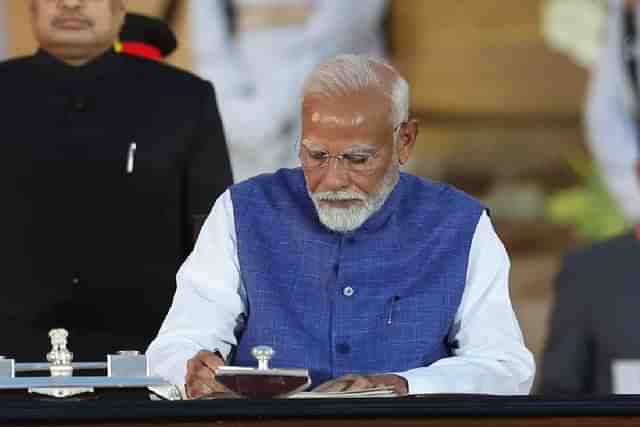 PM Narendra Modi signing after taking oath