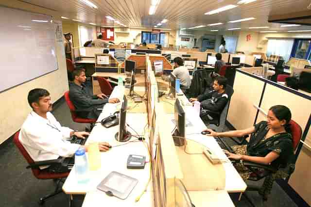 People working in an office in Bangalore, India. (Photo by Uriel Sinai/Getty Images) 