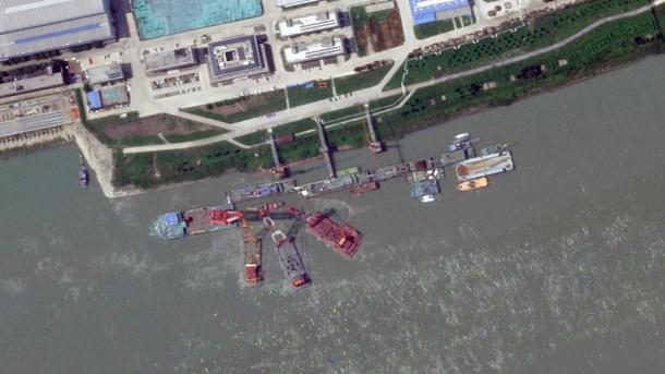 Four barges appears around 12 June at the Wuchang shipyard on the pier where the submarine sank. (Planet Labs)