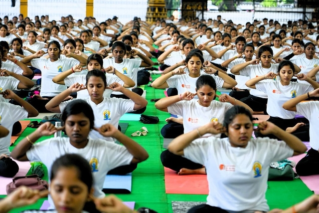 Students perform yoga.