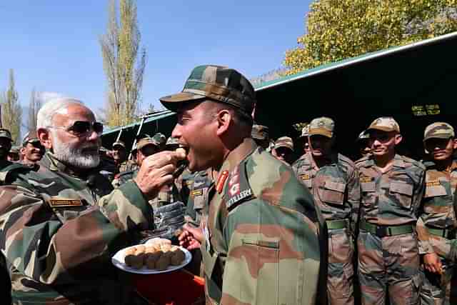 Prime Minister Narendra Modi exchanging sweets with Jawans (Narendra Modi/Twitter)