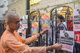 An ISKCON monk puts up posters outside the ISKCON temple in Kolkata