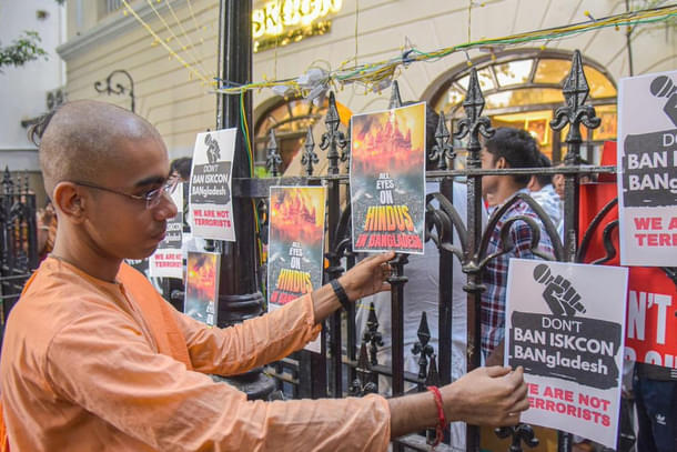 An ISKCON monk puts up posters outside the ISKCON temple in Kolkata