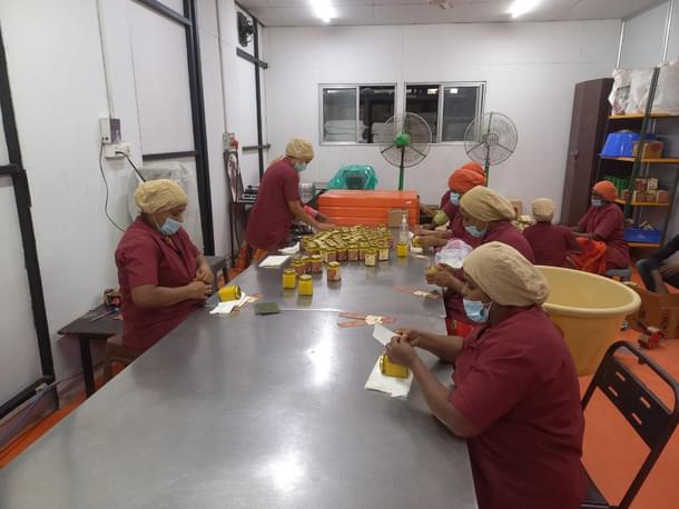 Ladies labelling ghee bottles (S Rajesh)