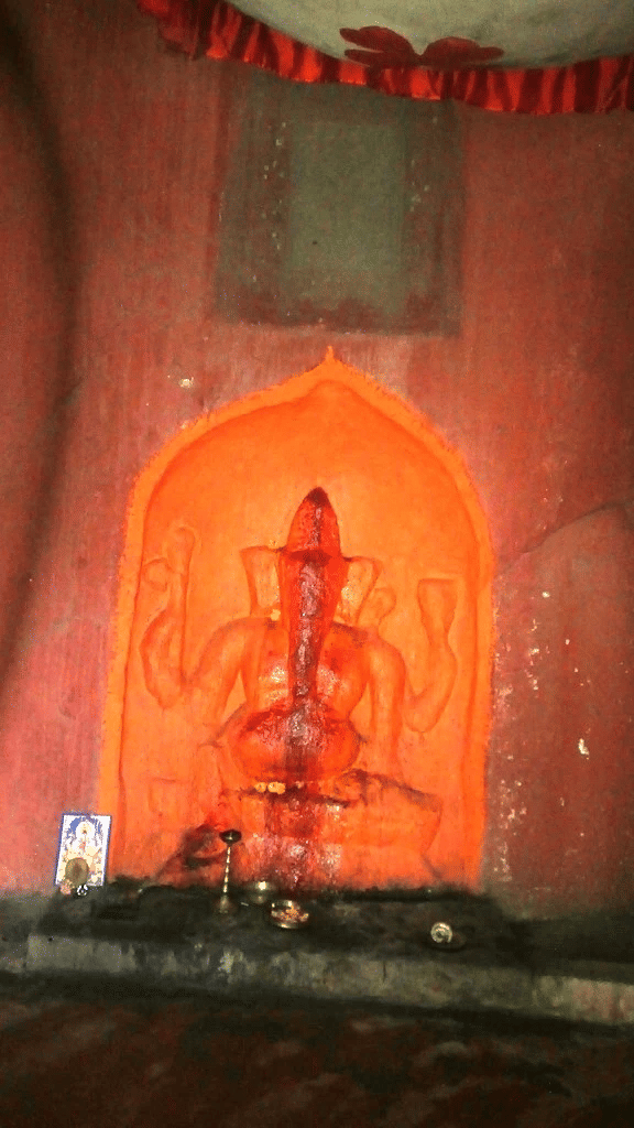 Inscription 3 (The inscription is on top with a Ganesha idol carved at the bottom. There is a concrete temple built around it where people offer prayers.)