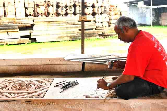 Worker cutting stone in workshop for preparation to build Ram temple (Burhaan Kinu/Hindustan Times via Getty Images)