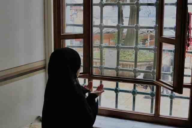 Muslim girl at window