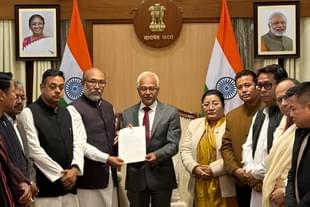 Manipur CM Biren Singh handing over his resignation to Governor Ajay Bhalla (centre, in suit)