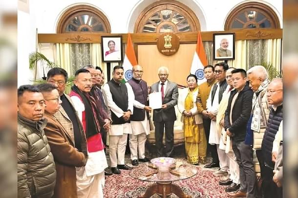 Manipur Chief Minister Biren Singh handing over his resignation to Governor Ajay Bhalla (centre, in suit)