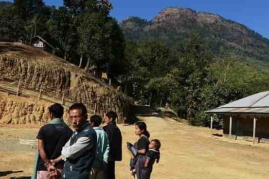 Manipur residents stand near a mountain in Tamenglong around 80 km west of Imphal. Photo credit:DIBYANGSHU SARKAR/AFP/GettyImages