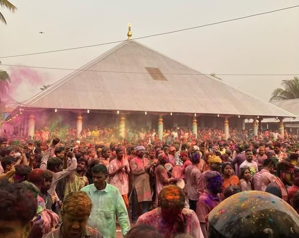 People play with phakuguri (gulal) in the courtyard of the Barpeta Satra