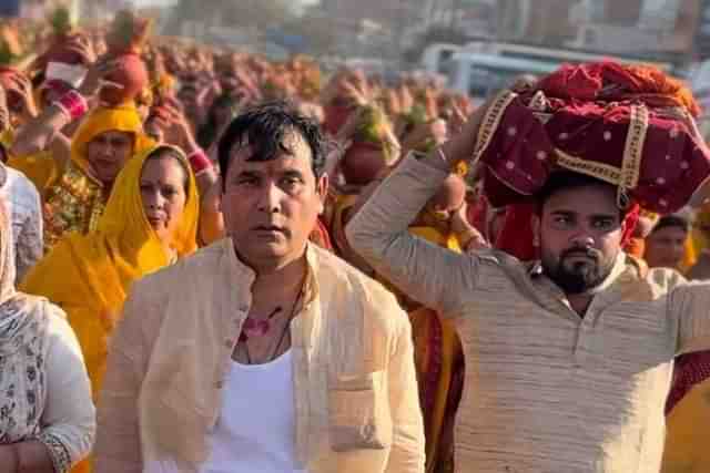 Nand Kishor Gurjar (L) walking in Kalash Yatra with torn clothes