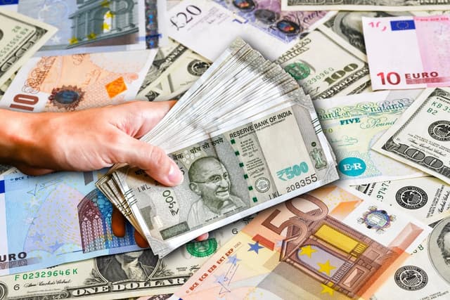 Indian (foreground) and foreign currencies including the US Dollar, Pound, and Euro.