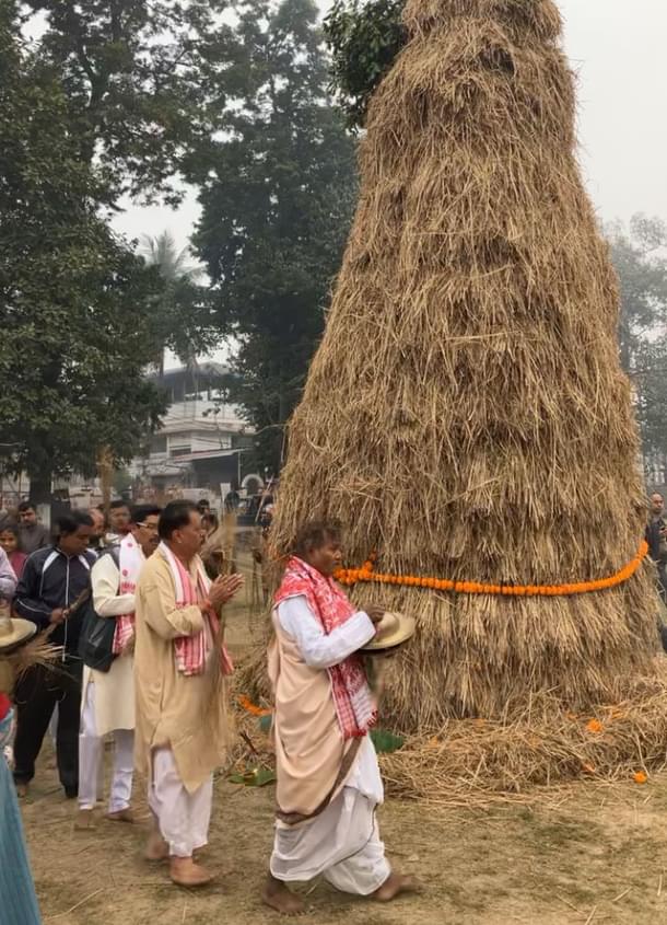 Prayers being offered around the meji before the ceremonial burning on Magh Bihu