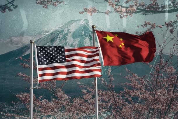 US and China flags with Japan's Mount Fuji in the background.