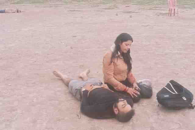 A wife sitting besides her dead husband after Pahalgam terror attack