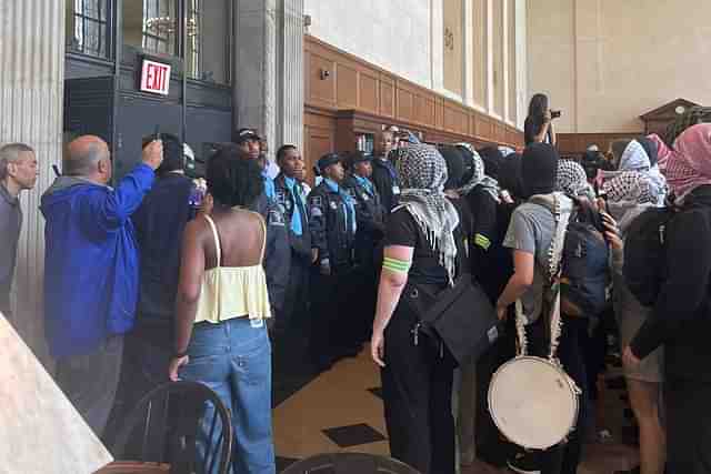 Radical pro-Palestine protesters in front of Columbia University Library. (@ClayTravis X account)