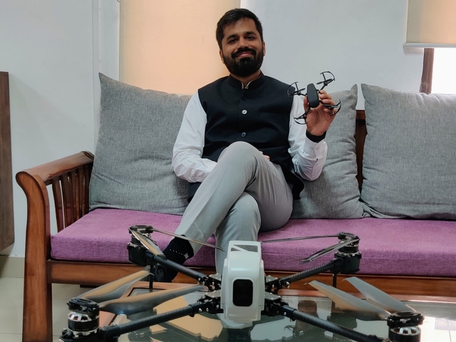 Shah holding a micro drone