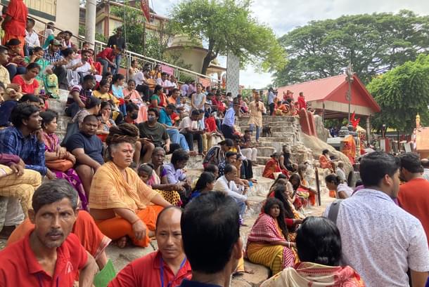 Devotees, sadhus, sanyasis, organisers sit around the Kamakhya Temple