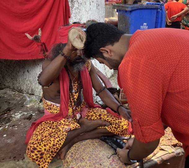 The same sadhu blessings another devotee