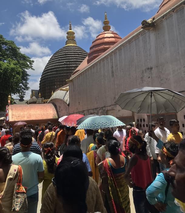 Devotees performing pradakshina of the temple with umbrellas. Even in the blazing heat of Guwahati, millions seek the blessings of Kamakhya even as she cannot be seen.