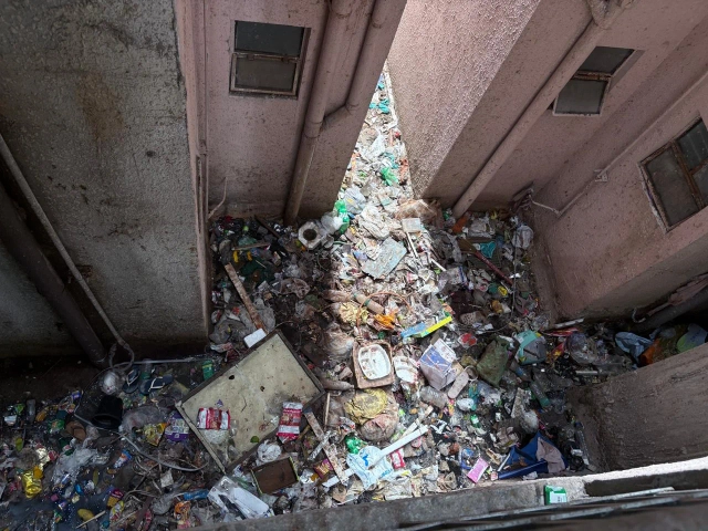 Waste dumped in open spaces within towers. 