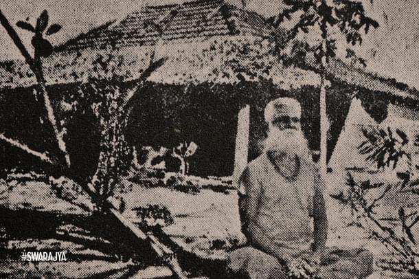 Swami Ambananda in front of the hut that was his Ashram.