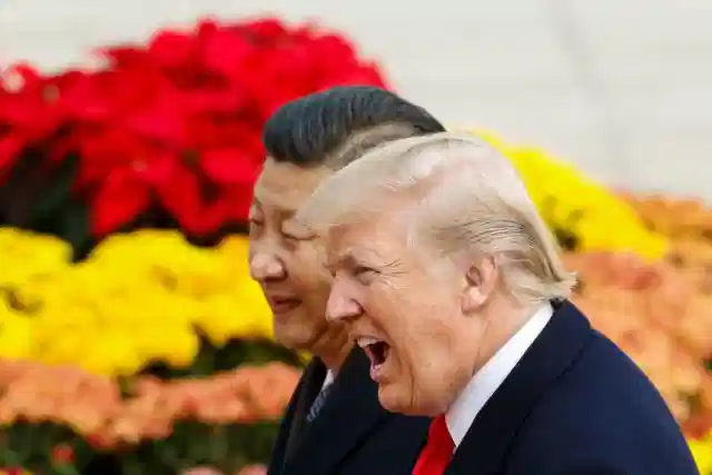 US President Donald Trump takes part in a welcoming ceremony with China’s President Xi Jinping. (Thomas Peter-Pool/Getty Images)