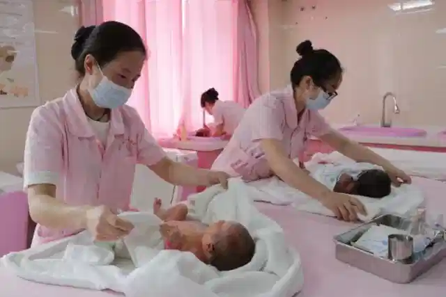 Nurses care for newborns at a hospital nursery in China. 
